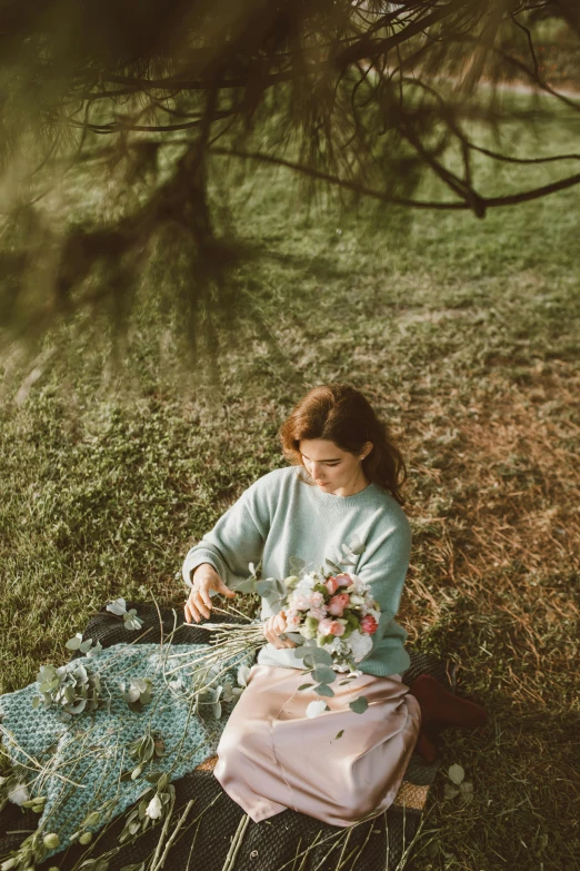 a woman sitting on top of a lush green field, inspired by Oleg Oprisco, trending on unsplash, having a picnic, with frozen flowers around her, portrait image, flatlay