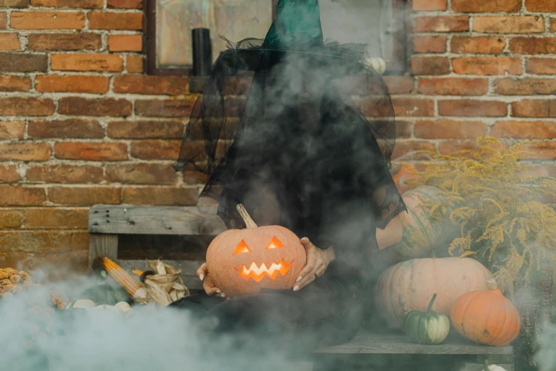 a couple of pumpkins sitting on top of a table, pexels contest winner, smoke coming out of her mouth, a black cloak, over the garden wall, dry ice