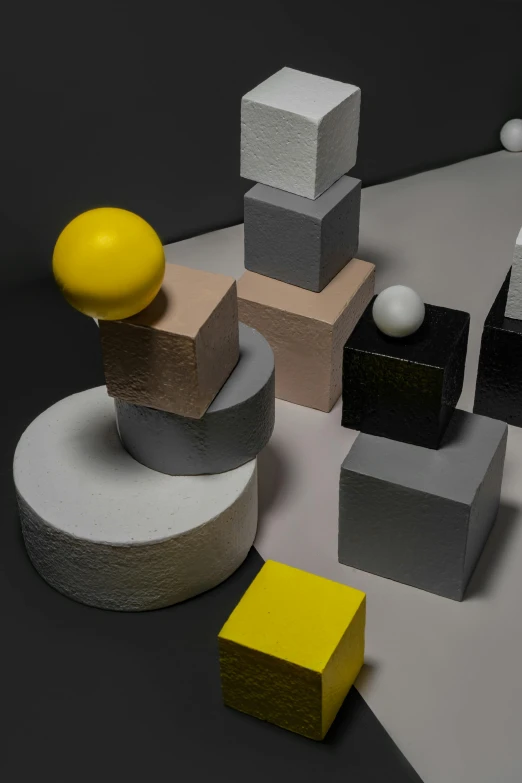 a bunch of cubes sitting on top of a table, inspired by Bauhaus, spheres, yellow charcoal, dramatic product shot, square