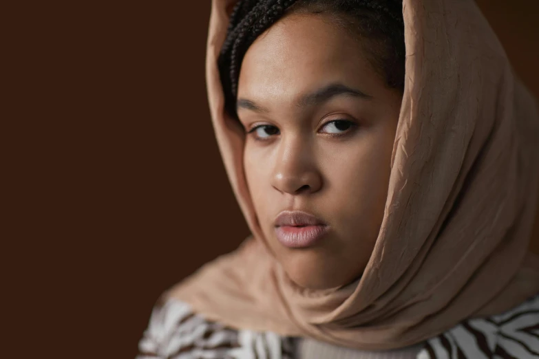 a close up of a person wearing a scarf, an album cover, by Lily Delissa Joseph, hyperrealism, timid and vulnerable expression, modest, wearing a brown, photo from a promo shoot