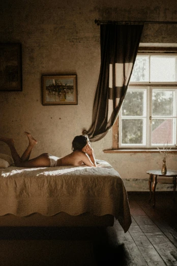 a woman laying on top of a bed next to a window, inspired by Balthus, unsplash contest winner, australian tonalism, located in a castle, denmark, panoramic view of girl, “ sensual