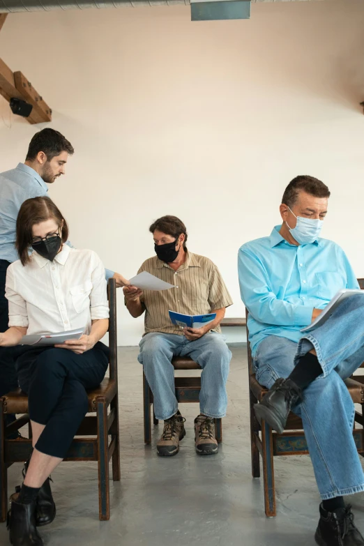 a group of people sitting in chairs in a room, wearing a mask, test, dressed in a worn, waiting room