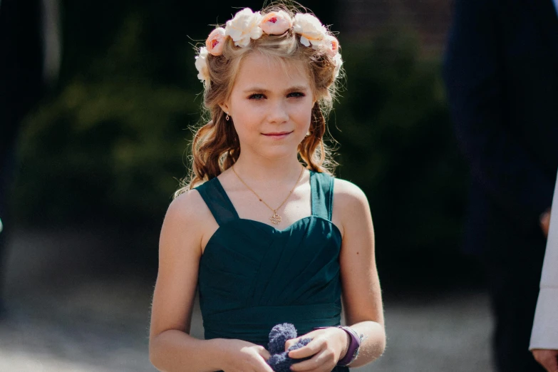 a young girl in a green dress with flowers in her hair, pexels contest winner, crown of mechanical peach roses, teal color graded, wedding, performing