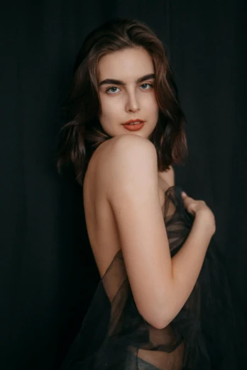 a woman in a black dress posing for a picture, by irakli nadar, trending on pexels, smooth pale skin, brown haired, medium format. soft light, gif