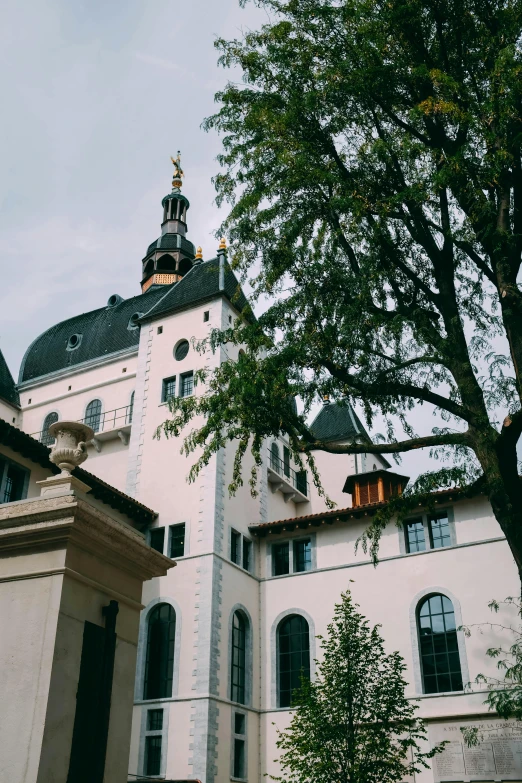 a large white building with a clock tower, inspired by Mihály Munkácsy, heidelberg school, with black vines, golden towers, grainy quality, dome