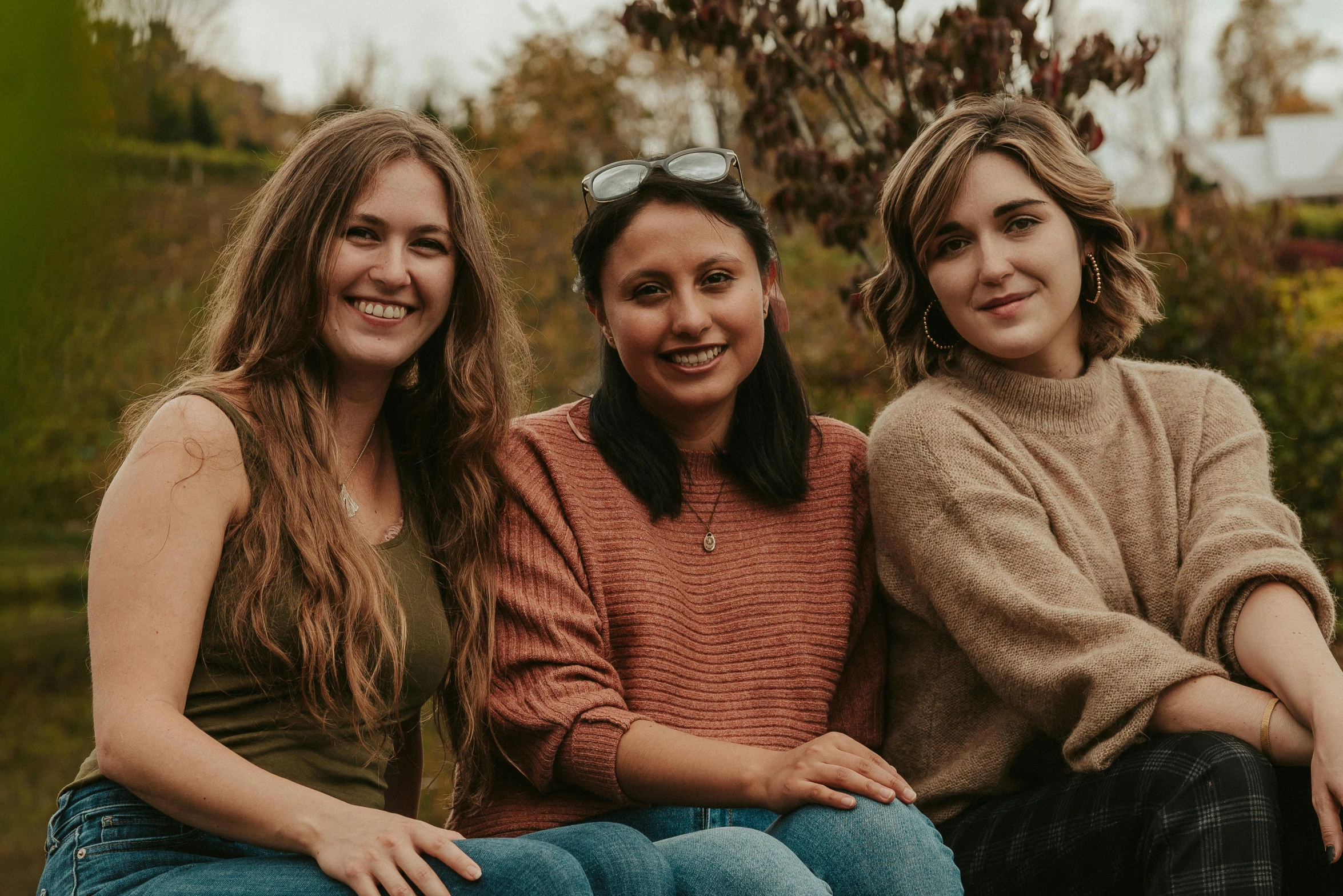 three women sitting next to each other on a bench, pexels contest winner, happening, all looking at camera, autumnal, avatar image, profile image