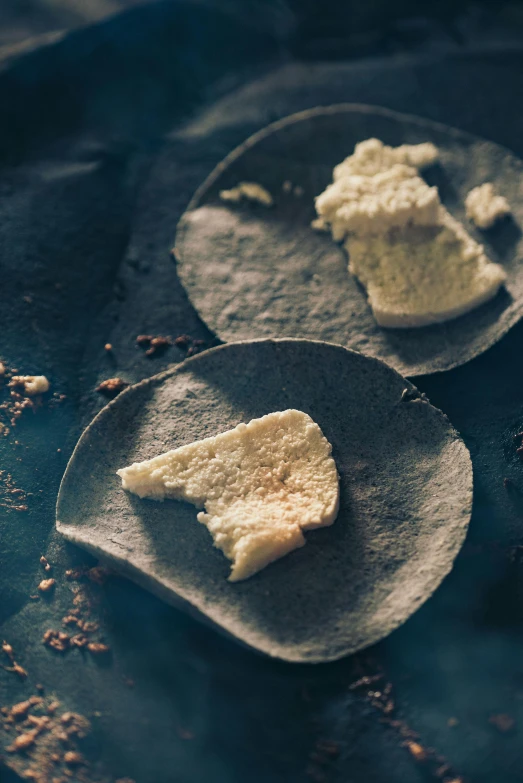 a couple of plates that have some food on them, by Elsa Bleda, unsplash, renaissance, white rocks made of bone, chewing tobacco, high angle close up shot, (cheese)