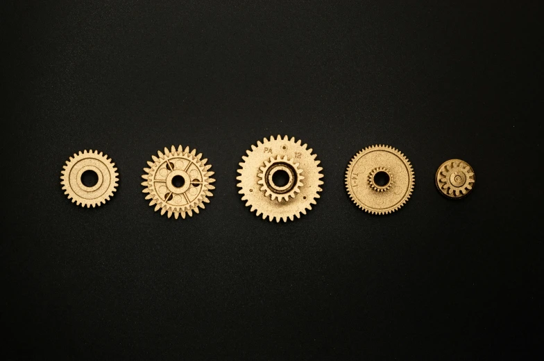 a number of gears on a black surface, unsplash, brass plated, product introduction photo, tooth wu : : quixel megascans, knolling