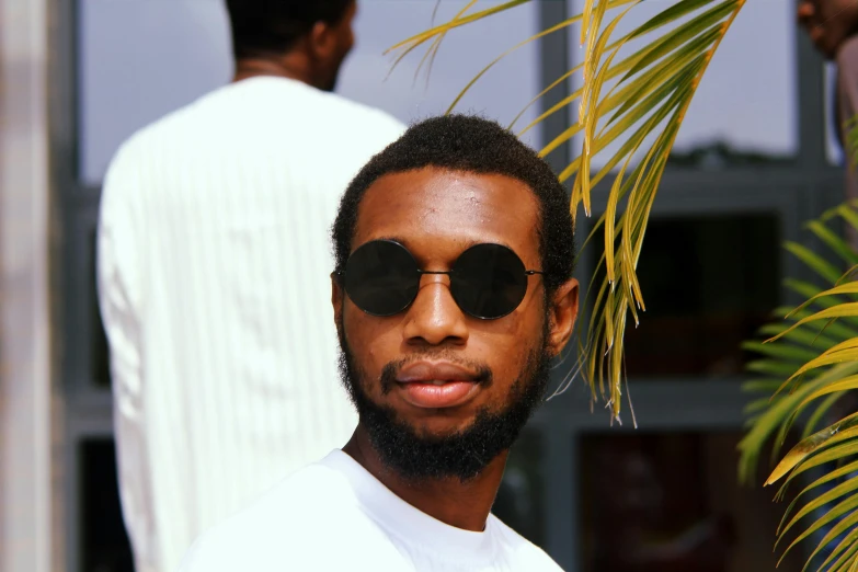 a close up of a person wearing sunglasses, by Chinwe Chukwuogo-Roy, pexels contest winner, renaissance, young man, avatar image, low quality photo, slight smirk