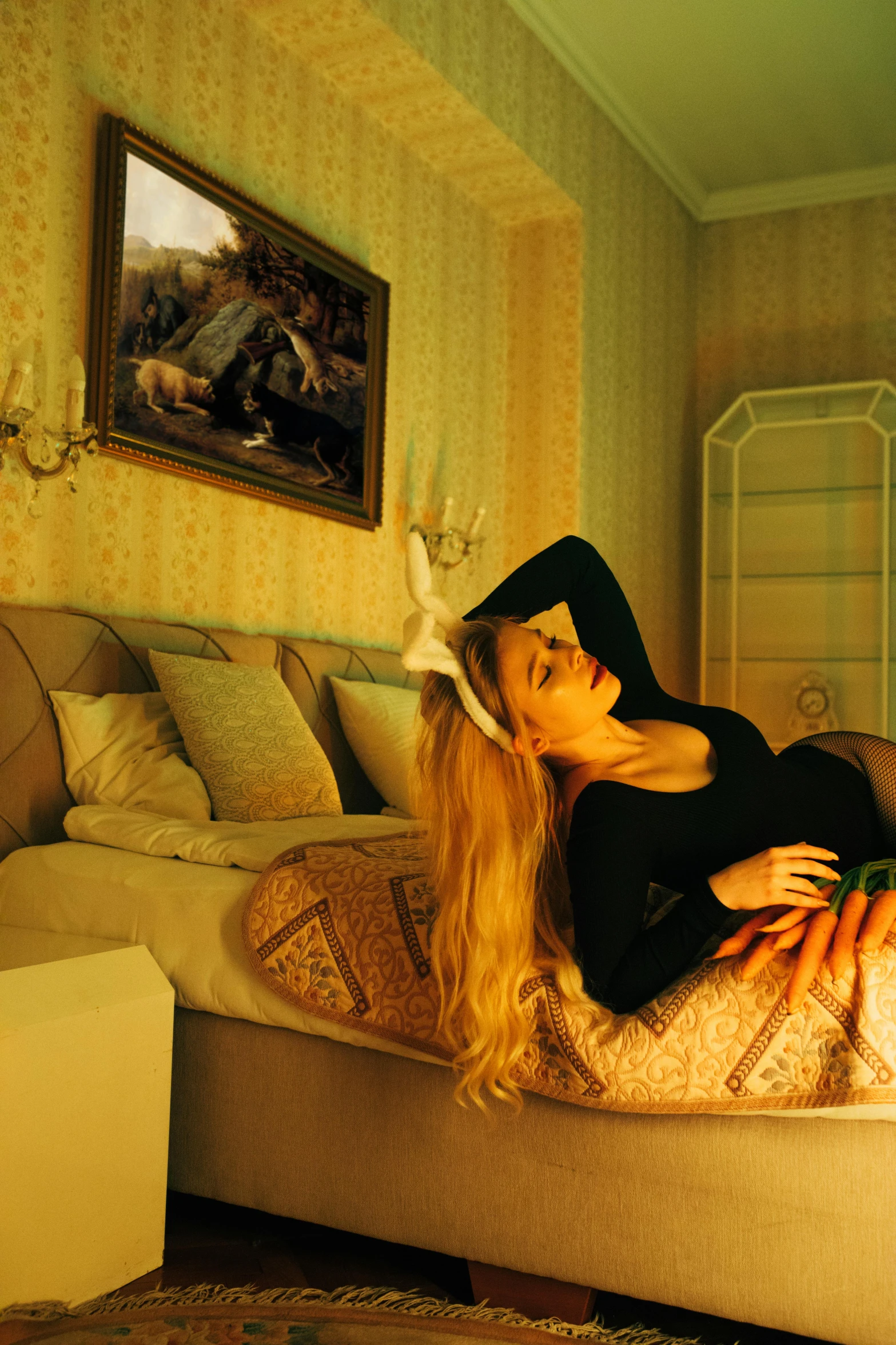 a woman laying on a bed in a room, an album cover, inspired by Elsa Bleda, magic realism, beautiful lady with bunny ears, mansion, blonde swedish woman, ultra realism