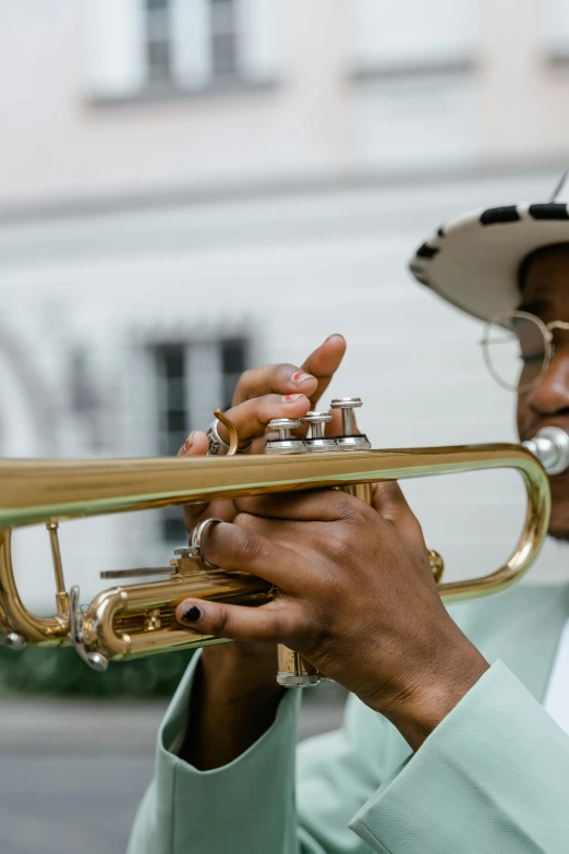 a man in a hat playing a trumpet, pexels contest winner, new orleans, zoomed in, high resolution photo, 🌻🎹🎼