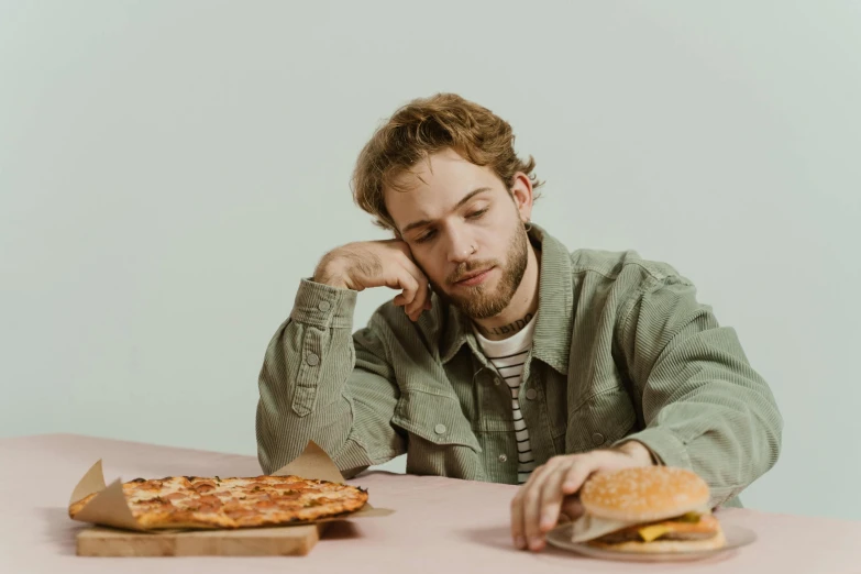 a man sitting at a table with a plate of food, trending on pexels, hyperrealism, looking tired, pizza the hut, hozier, slightly minimal