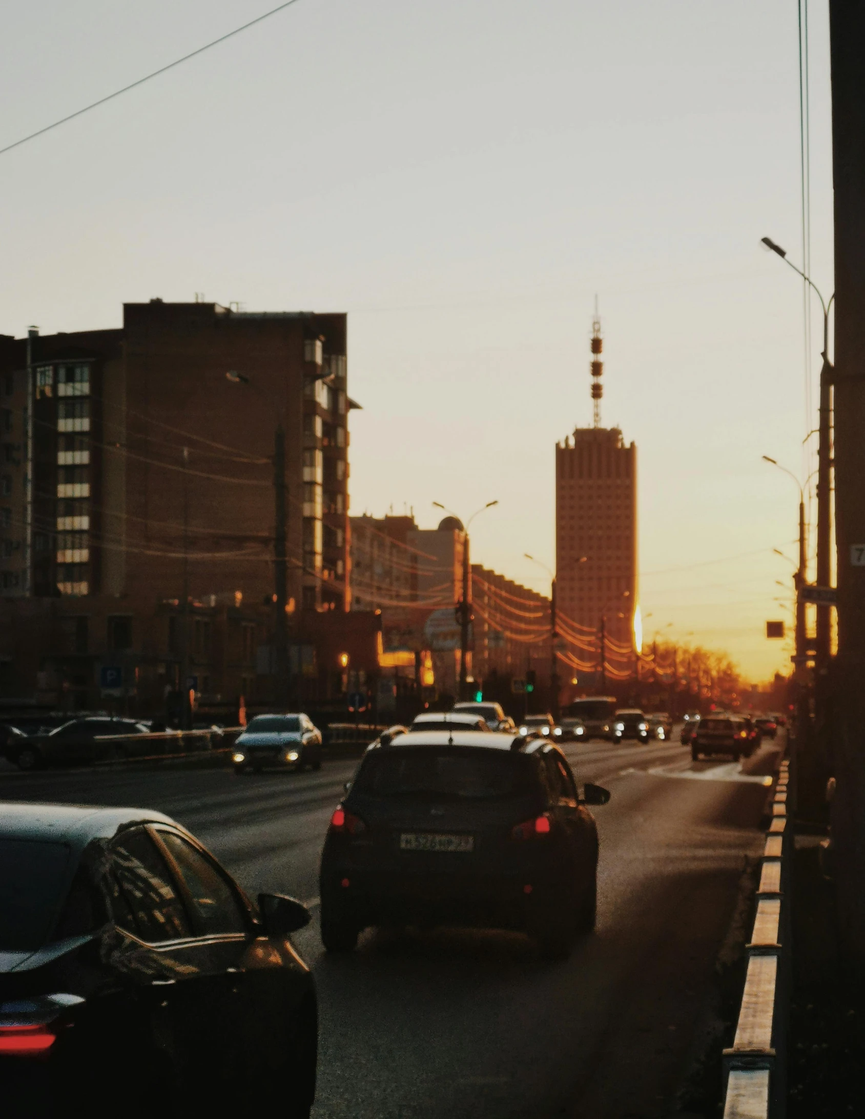 a street filled with lots of traffic next to tall buildings, an album cover, pexels contest winner, socialist realism, evening sun, saint petersburg, low quality photo, 000 — википедия