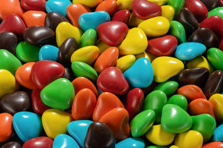 a pile of colorful candy sitting on top of a table, detailed product image, smooth rounded shapes, chocolate river, primary colours