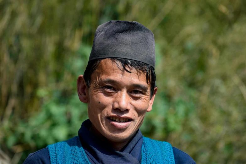 a close up of a person wearing a hat, by Jan Tengnagel, hurufiyya, nepal, avatar image, a handsome, maintenance photo