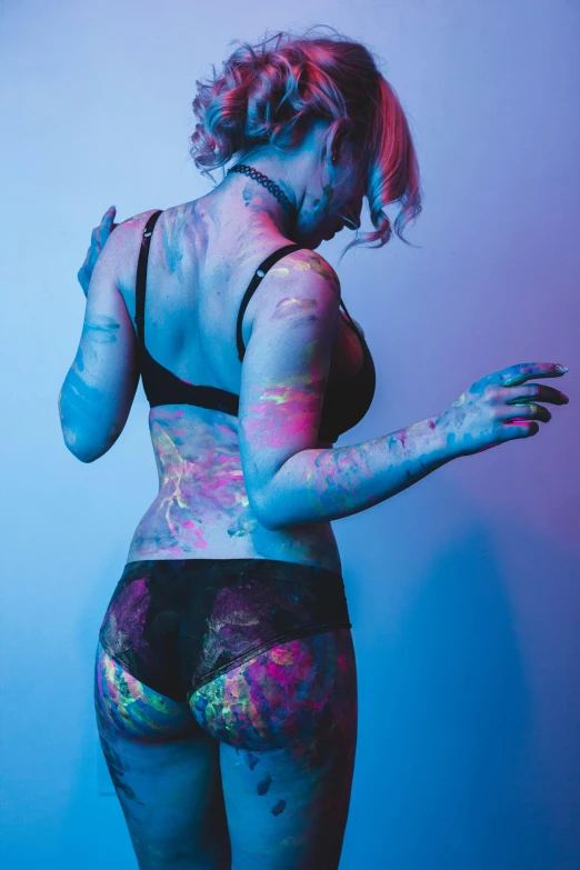 a woman with paint all over her body, a colorized photo, inspired by Elsa Bleda, trending on pexels, toned derriere, chloe price, bisexual lighting, black light