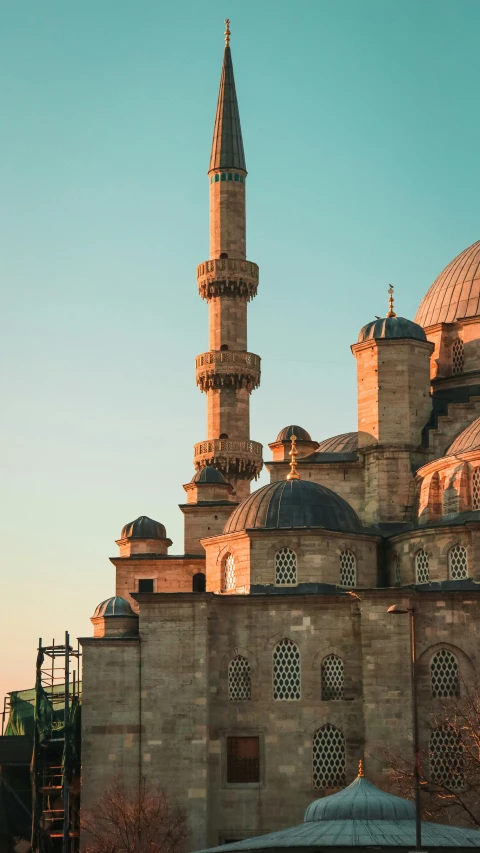 a large building with a clock tower in front of it, inspired by Osman Hamdi Bey, trending on pexels, renaissance, domes, morning light, lead - covered spire, 2 5 6 x 2 5 6
