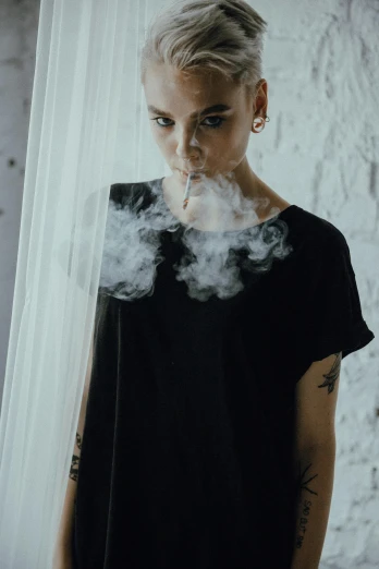 a woman standing in front of a window with smoke coming out of her mouth, antipodeans, wearing a black tshirt, shaved sides, marijuana smoke, (((mist)))