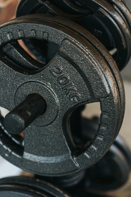 a pair of weights sitting on top of a table, profile image, close up details, detailed wheels, metal handles