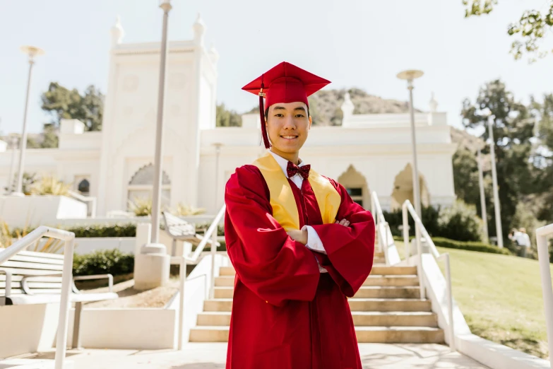 a woman in a graduation gown posing for a picture, unsplash, asian man, maroon and white, delightful surroundings, cal-arts