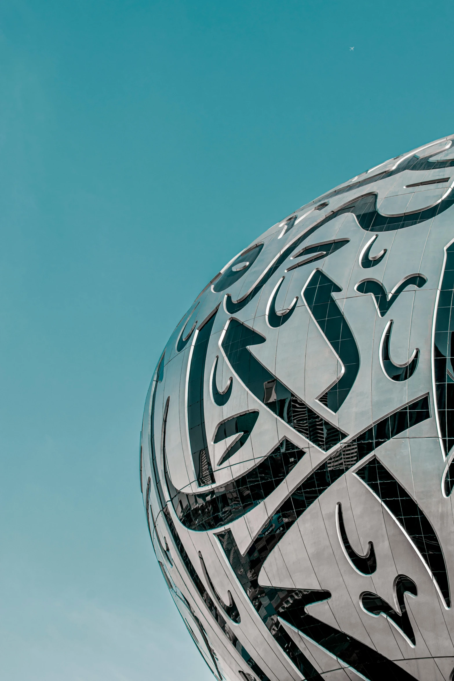 a large metal ball with arabic writing on it, inspired by Zha Shibiao, unsplash contest winner, zaha hadid building, intricate ”, round-cropped, arabia