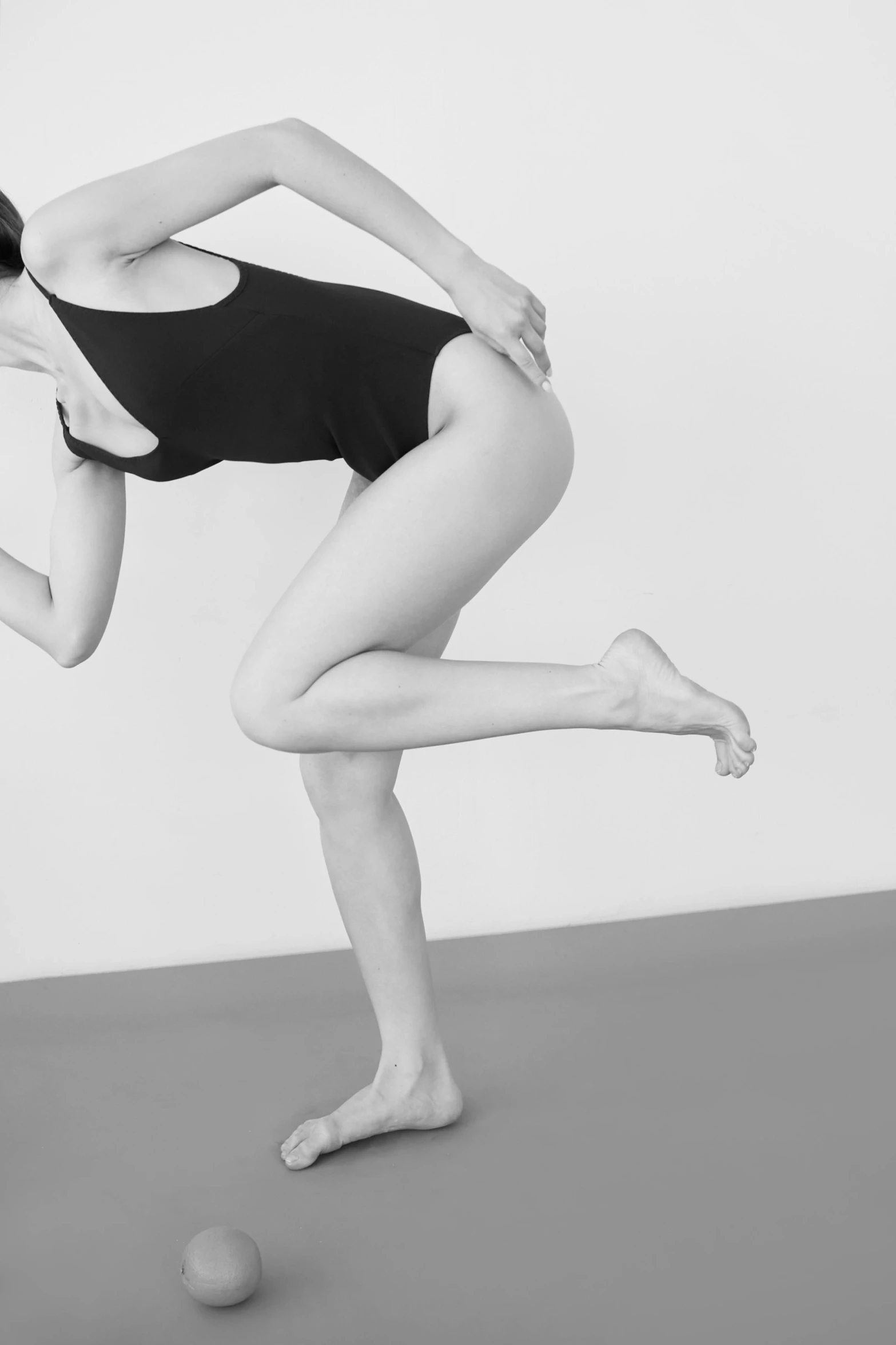 a woman in a leo leo leo leo leo leo leo leo leo leo leo leo leo leo, a black and white photo, by Clifford Ross, arabesque, marjaryasana and bitilasana, running sequence, part petra cortright, leg and hip shot