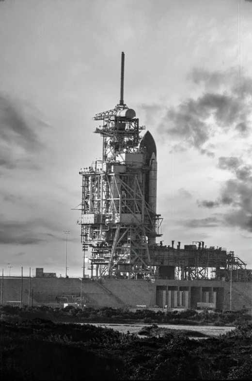 a black and white photo of a building under construction, a black and white photo, by Dave Melvin, spacex, sundown, highly detail, atlantis