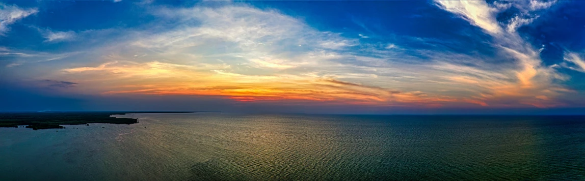 a large body of water under a cloudy sky, by Jan Tengnagel, pexels contest winner, romanticism, sunset panorama, drone photo, the emerald coast, from wheaton illinois