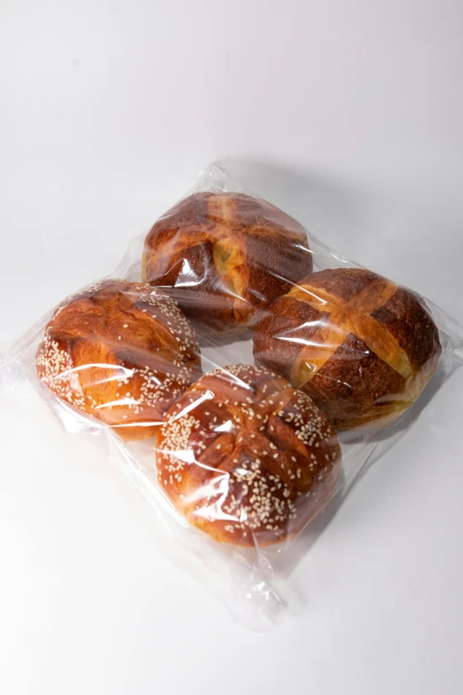 a bag of pretzels sitting on top of a table, steamed buns, on clear background, 6 pack, cross