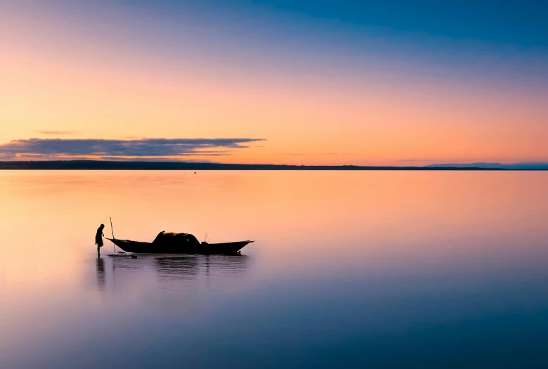 a small boat floating on top of a large body of water, by Eglon van der Neer, unsplash contest winner, madagascar, beautiful dusk, fisherman, at peace