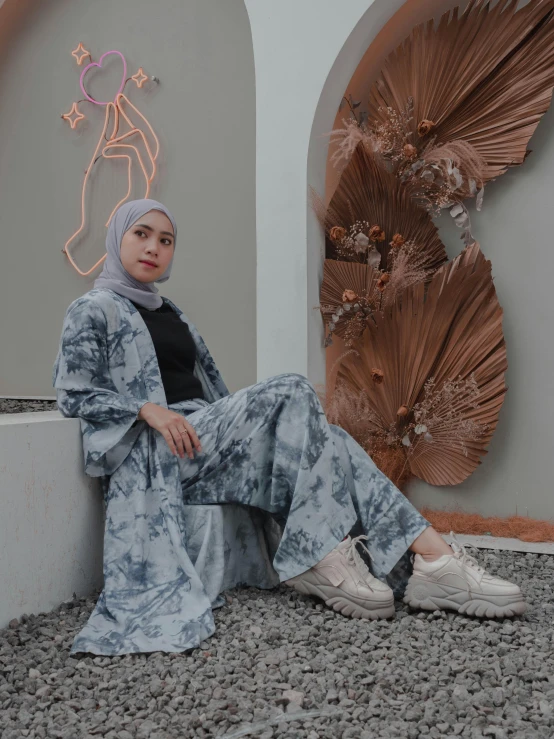 a woman wearing a hijab sitting on a wall, by Abidin Dino, grey and blue theme, wearing a baggy pajamas, marbling effect, 🎀 🧟 🍓 🧚