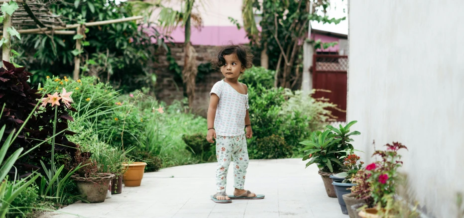 a little girl that is standing on a skateboard, by Alice Mason, happening, urban jungle, nivanh chanthara, standing outside a house, patterned