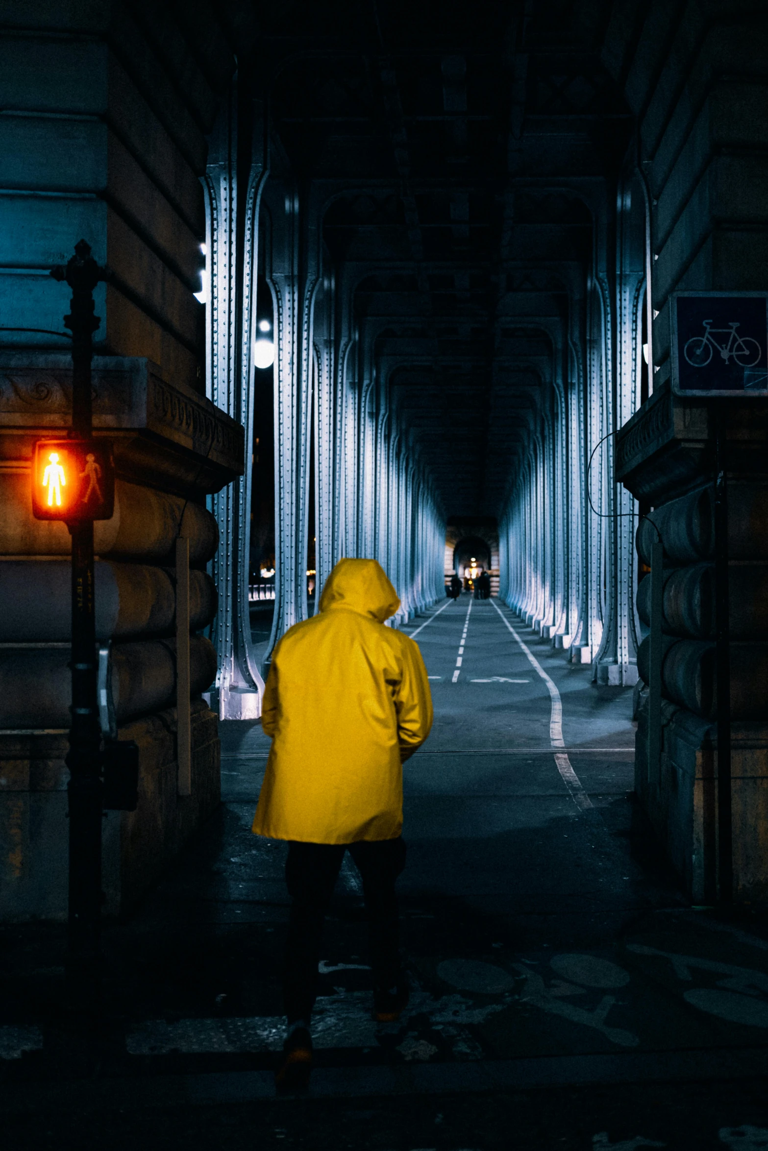 a person in a yellow raincoat walking down a dark street, unsplash contest winner, visual art, musee d'orsay 8 k, high walled tunnel, wearing a yellow hoodie, sad lighting