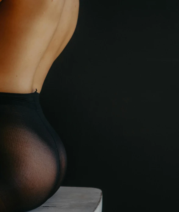 a close up of a person in a tight pantyhost, unsplash, figuration libre, exposed back, smooth in _ the background, product shot, wrapped in black