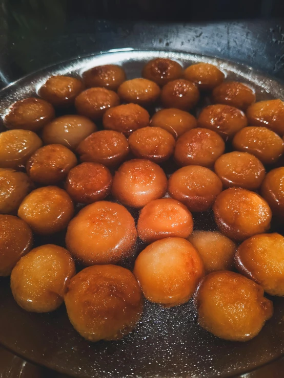 a close up of a frying pan filled with food, dessert, puṣkaracūḍa, thumbnail, round shapes