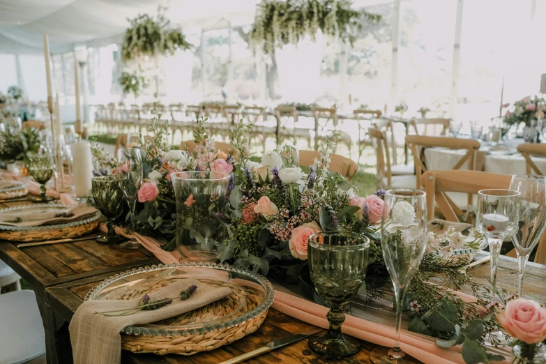 a table that has a bunch of place settings on it, pexels contest winner, renaissance, marquee, flowers in foreground, long table, rustic setting