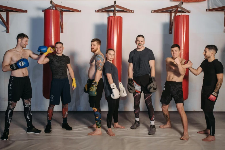 a group of men standing next to each other, by Ilya Ostroukhov, pexels contest winner, kickboxing, mid-transformation, background image, family photo