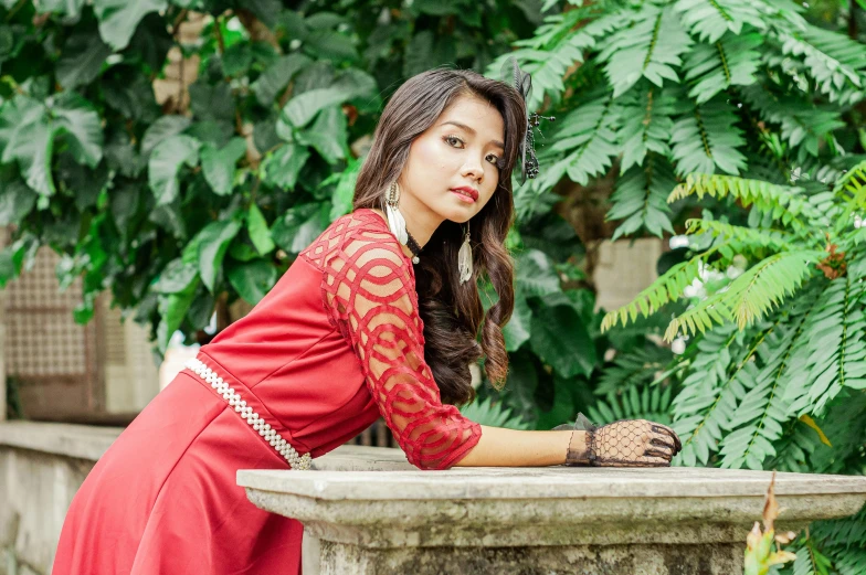 a woman in a red dress posing for a picture, a portrait, by Julia Pishtar, pixabay, sumatraism, in lace brown dress, young asian woman, assamese aesthetic, side pose