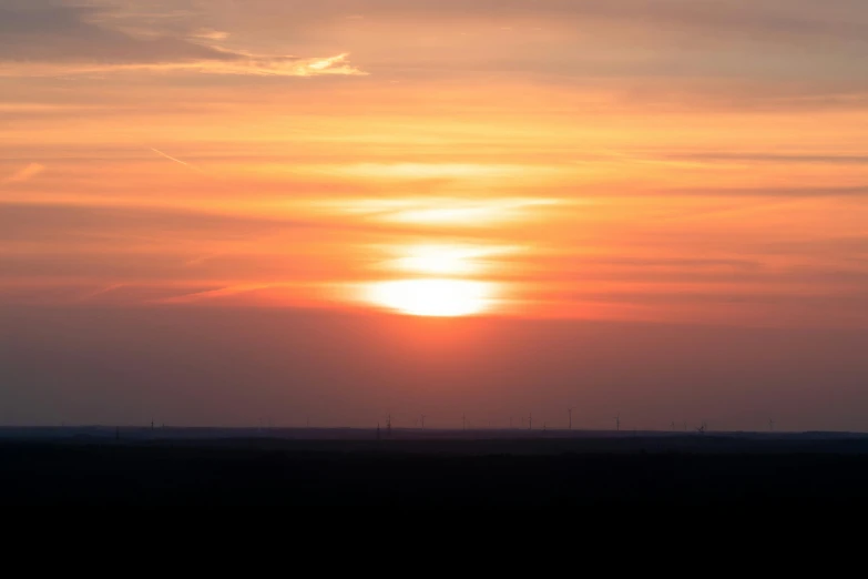 a person is flying a kite at sunset, by Linda Sutton, pexels contest winner, romanticism, panorama distant view, nuclear sunset, steppe, at sunrise in springtime