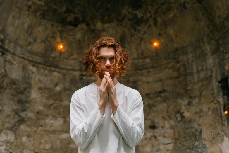 a man in a white shirt is praying, by Emma Andijewska, pexels contest winner, renaissance, ginger wavy hair, stood in a tunnel, felix englund style, monk