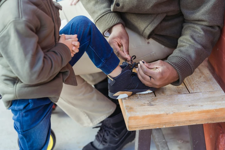 a man and a little boy sitting on a bench, pexels contest winner, sneaker design, craftsmanship, school class, fatherly