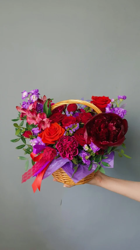 a person holding a basket full of flowers, red and purple palette, red velvet, vibrant accents, fan favorite