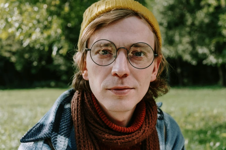 a close up of a person wearing glasses and a scarf, inspired by Wes Anderson, unsplash, antipodeans, looks like domhnall gleeson, olivia kemp, mid length portrait photograph, cottage hippie naturalist
