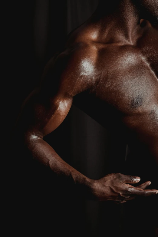 a shirtless man standing in front of a black background, closeup of arms, dark black skin tone, physicality-based render, a photo of a man