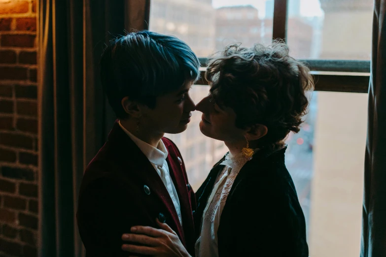 a couple of people standing in front of a window, inspired by Nan Goldin, pexels contest winner, lesbian kiss, rebecca sugar, ignant, profile image