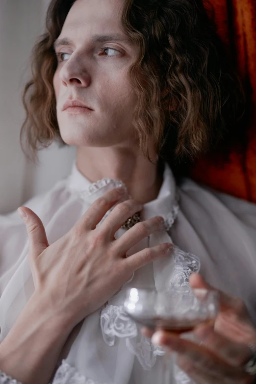 a close up of a person holding a glass of wine, an album cover, inspired by Jan Lievens, rococo, delicate androgynous prince, white russian clothes, adam ondra, wearing collar