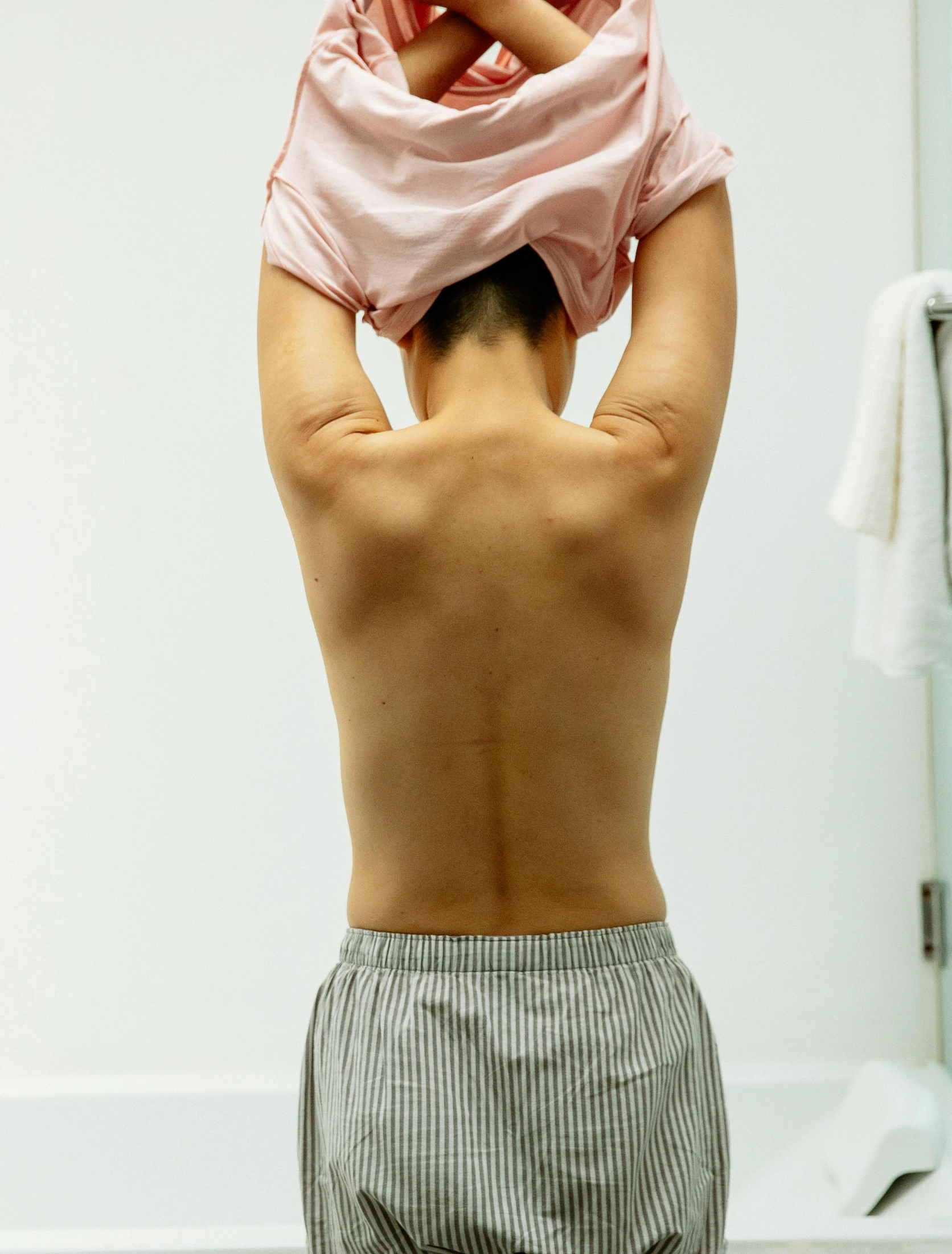 a man standing in front of a mirror holding a baby, a statue, by Tadashige Ono, bare back, sport bra and shirt, medical image, showers