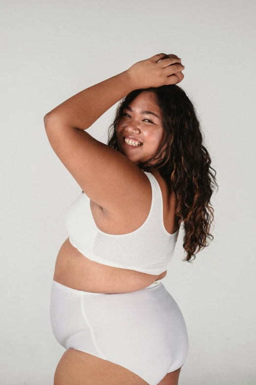 a woman in a white underwear posing for a picture, inspired by Ruth Jên, unsplash, happening, slightly overweight, wearing a cropped tops, health supporter, catalog photo