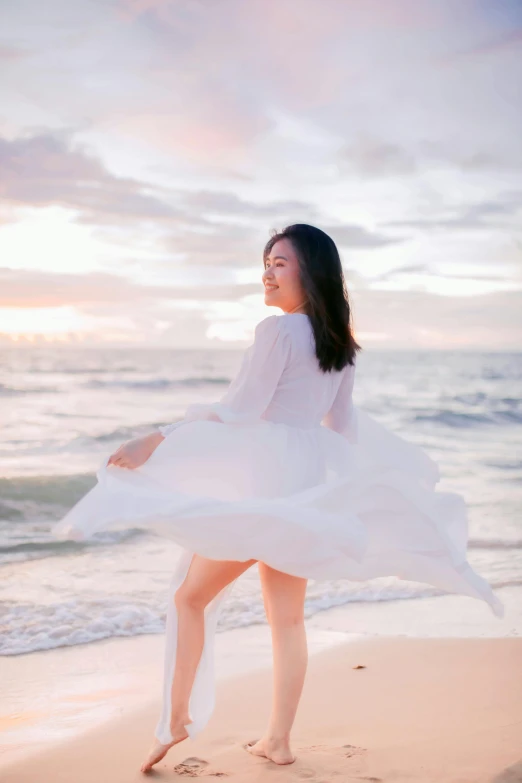 a woman in a white dress standing on a beach, an album cover, by Tan Ting-pho, unsplash, young asian girl, girl running, soft glow, ( ( ( kauai ) ) )