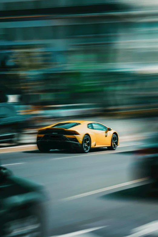 a yellow sports car driving down a city street, pexels contest winner, high speed photography, lamborghini, thumbnail, 24mp